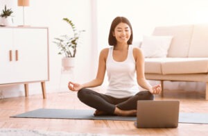 millennial woman meditating with trainer online on 26KV3U3 300x196 1